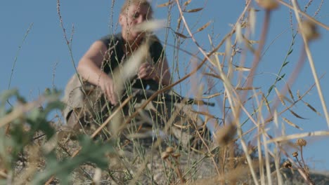 Ranger-female-soldier-taking-his-weapon-from-the-floor