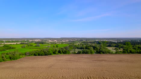 Expansive-aerial-view-of-farmland-and-village-in-Bernis,-France