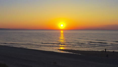 Aerial-drone-fly-sunrise-skyline-golden-sun-shine-above-beach-sandy-water-shore-Findhorn-Scotland