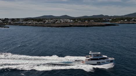 Luxury-boat-driving-at-sea-next-to-Spanish-island-of-Mallorca-filmed-with-drone-in-slow-motion