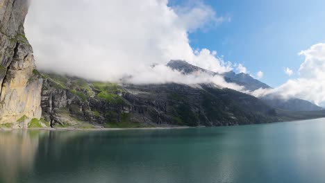 Aerial-flight-over-a-beautiful-big-Oeschinen-lake-on-a-mountain-in-Switzerland