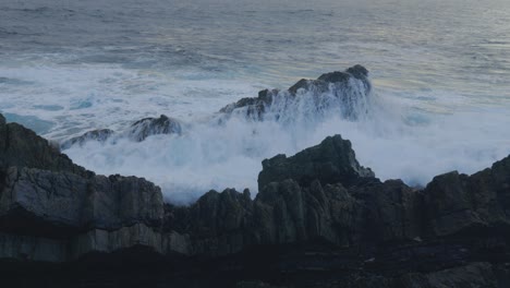 Nahaufnahme-Einer-Großen-Welle-In-Zeitlupe,-Die-Gegen-Einen-Rauen-Felsen-Entlang-Der-Australischen-Küste-Prallt