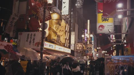 Dotonbori-Street-On-Rainy-Night-With-Crowd-of-People-In-Osaka,-Japan