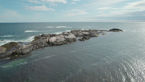 Drone-footage-taking-off-from-the-rocky-shores-of-Narragansett-Bay-out-over-the-water