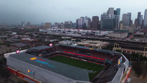 Aerial-view-around-the-Shell-energy-stadium,-dark,-storm-weather-in-Houston,-USA