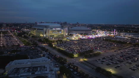 Drone-approaching-the-NRG-Stadium,-during-Houston-Livestock-Show-and-Rodeo-evening