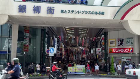 Colorful-entrance-to-a-busy-Japanese-shopping-arcade-with-stained-glass-decorations