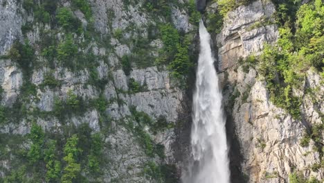 Aerial-view-of-Seerenbachfälle-in-Amden-Betlis,-Walensee,-Switzerland,-where-cascading-waters-tumble-down-dramatic-cliffs,-epitomizing-the-power-and-beauty-of-nature