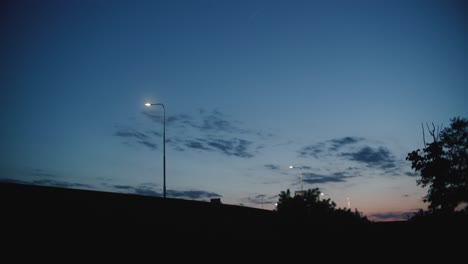 Shot-of-a-sunset-with-car-passing-in-front