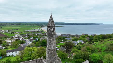 Ireland-Epic-locations-drone-passes-close-to-the-top-of-Ardmore-Round-Tower-and-views-of-the-sea-at-Ardmore-Village-in-Waterford