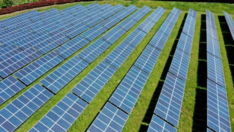 Rows-of-solar-panels-on-a-sunny-day,-aerial-view