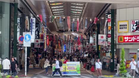 Busy-Japanese-shopping-arcade-with-colorful-banners-and-bustling-crowd
