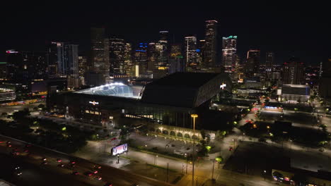 Aerial-view-around-the-iIlluminated-Minute-Maid-park,-night-in-Houston,-USA