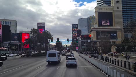 Daily-Traffic-on-Las-Vegas-Strip-on-Cloudy-Day,-Vehicles,-Casino-Hotel-Buildings-POV