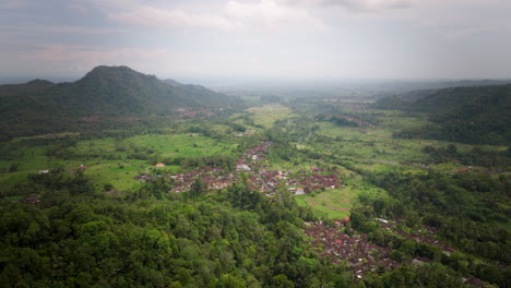 Panoramic-aerial-over-tropical-jungle-ridge-to-Sidemen-Bali-on-overcast-day