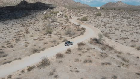 Following-a-SUV-down-a-dirt-trail-to-the-mountains