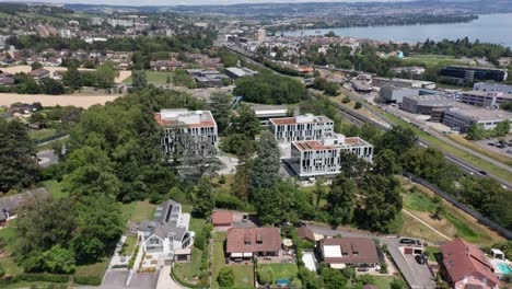 Jib-down-of-a-beautiful-apartment-complex-in-a-small-suburban-town-on-a-sunny-day-in-Switzerland