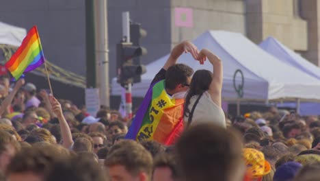 Couple-making-heart-shape-with-their-hands-in-symbol-of-love-during-pride-day-celebrations