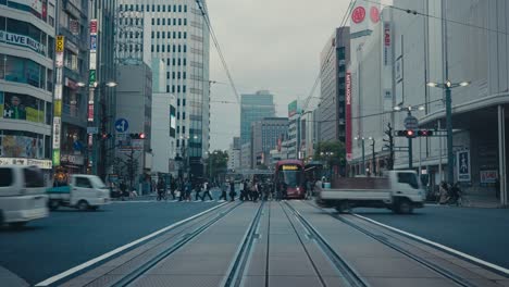 Fußgänger-Und-Fahrzeuge-überqueren-Eine-Belebte-Straße-In-Der-Stadt-Hiroshima,-Japan