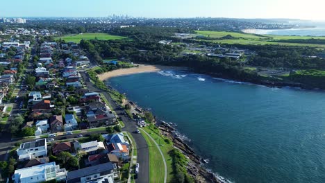 Landscape-headland-coastline-ocean-view-of-Malabar-beach-waves-Maroubra-Sydney-residential-street-roads-town-homes-drone-aerial-CBD-skyline