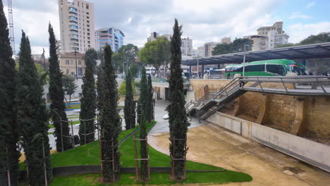 A-view-of-a-modern-urban-area-in-Nicosia,-Cyprus,-with-cypress-trees-and-high-rise-buildings,-captured-in-slow-motion