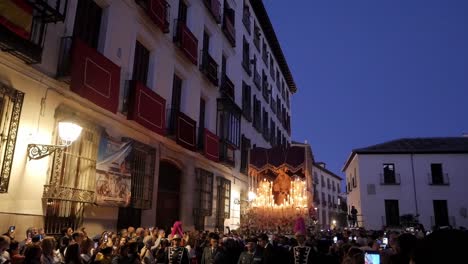 Wide-shot-capturing-the-crowd-around-a-"paso"-float-with-a-statue-of-the-Virgin-Mary-swaying-gently-as-it's-carried-through-the-city