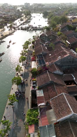 Aerial-view-of-tourists-walking-beside-the-Hoai-River-in-Hoi-An,-Vietnam