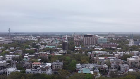 Low-reverse-pullback-aerial-shot-over-Forsyth-Park-in-downtown-Savannah,-Georgia