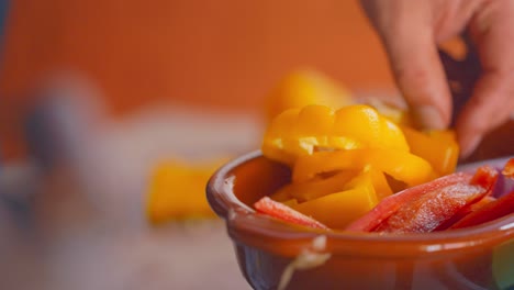 A-simple-knife-cutting-of-a-yellow-pepper-then-puting-in-a-container
