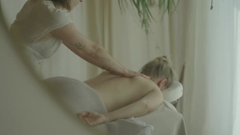 A-relaxing-massage-session-in-a-serene,-softly-lit-room-with-calming-natural-decor