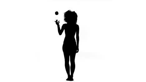 Woman-throwing-and-catching-an-apple-in-slow-motion