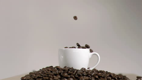 Coffee-beans-dropping-in-cup-in-super-slow-motion