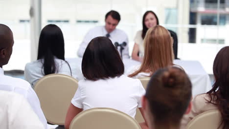 Woman-raises-her-hand-to-ask-question