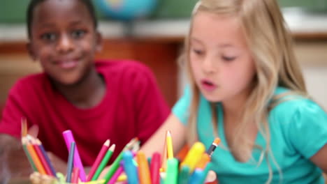 Pupils-sitting-behind-coloring-pens