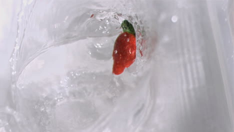 Strawberry-falling-into-water-in-super-slow-motion