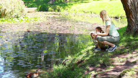 Mother-and-daughter-nourishing-ducks-