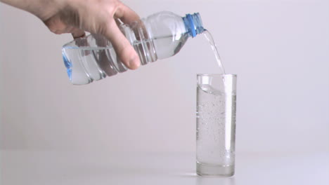 Still-water-flowing-in-super-slow-motion-from-a-small-bottle