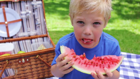 Boy-eating-a-watermelon-and-smiling