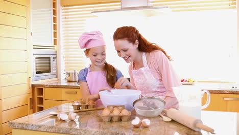 Smiling-mother-and-daughter-cooking