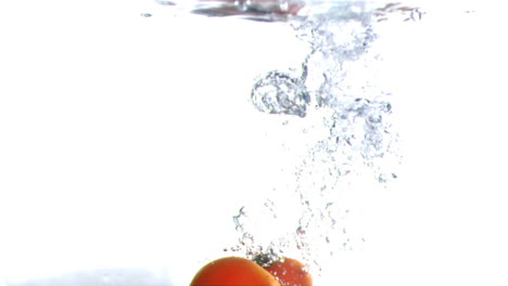 Tomatoes-falling-into-water-in-super-slow-motion