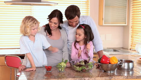 Familia-Sonriente-Haciendo-Una-Ensalada