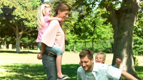 Parents-in-slow-motion-giving-their-children-a-piggyback