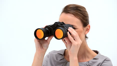 Smiling-businesswoman-looking-through-binoculars