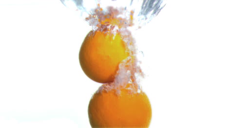 Grapefruits-dropped-into-water-in-super-slow-motion