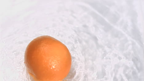 Orange-turning-in-water-in-super-slow-motion