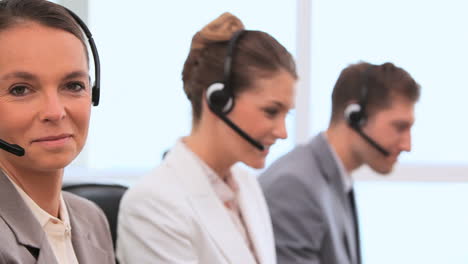Smiling-business-people-working-with-headsets