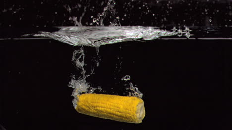 Corn-cob-falling-into-water-in-super-slow-motion