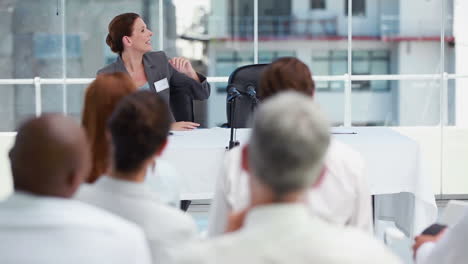 Businesswoman-welcoming-a-speaker