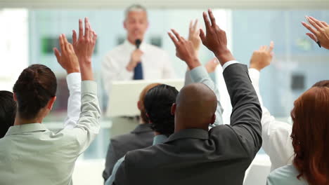 Business-people-raising-their-hands-together