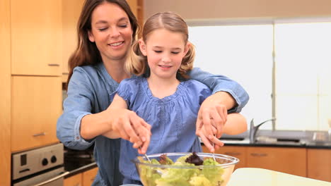 Mother-and-daughter-mixing-a-salad